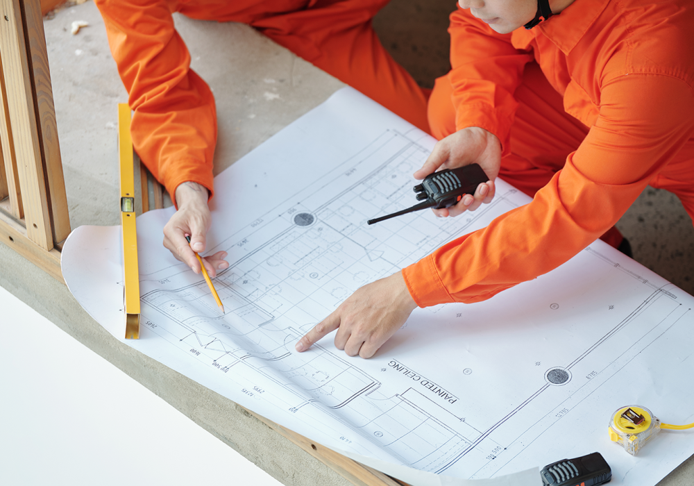 construction-workers-pointing-at-building-blueprin-2021-12-09-05-02-41-utc construction-workers-pointing-at-building-blueprin-2021-12-09-05-02-41-utc